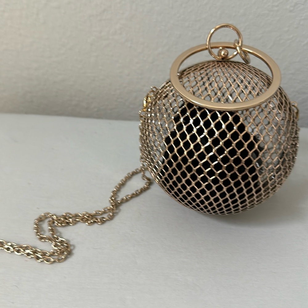 Gold metal bag in a shape of a ball